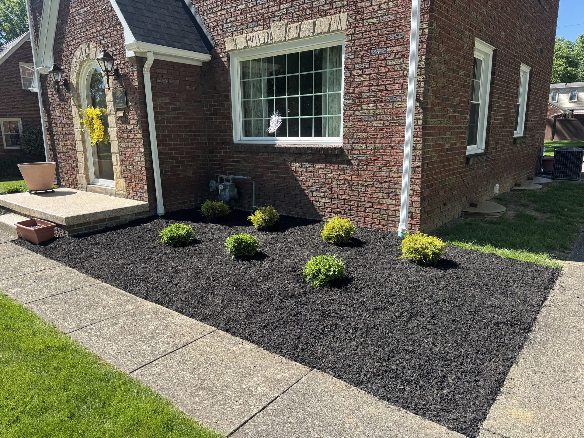 Finished landscaping beds with fresh mulch after a full property refresh